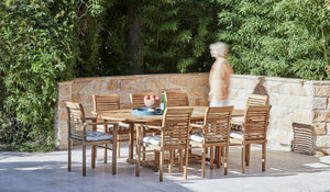 teak arm chairs around oval teak outdoor table