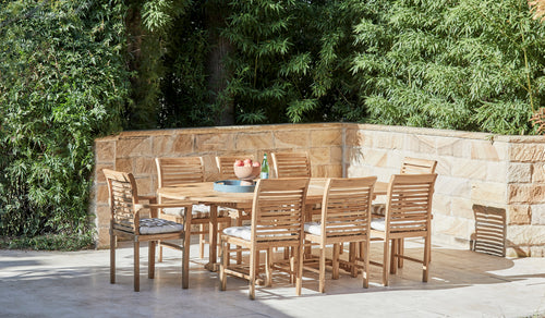 teak arm chairs around oval teak outdoor table