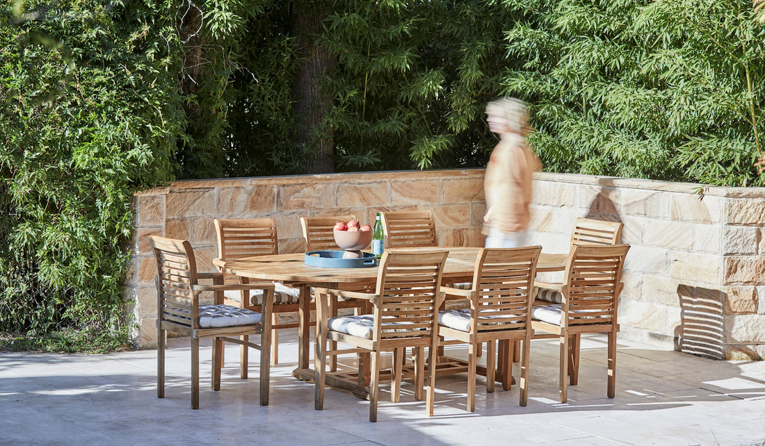 teak arm chairs around oval teak outdoor table