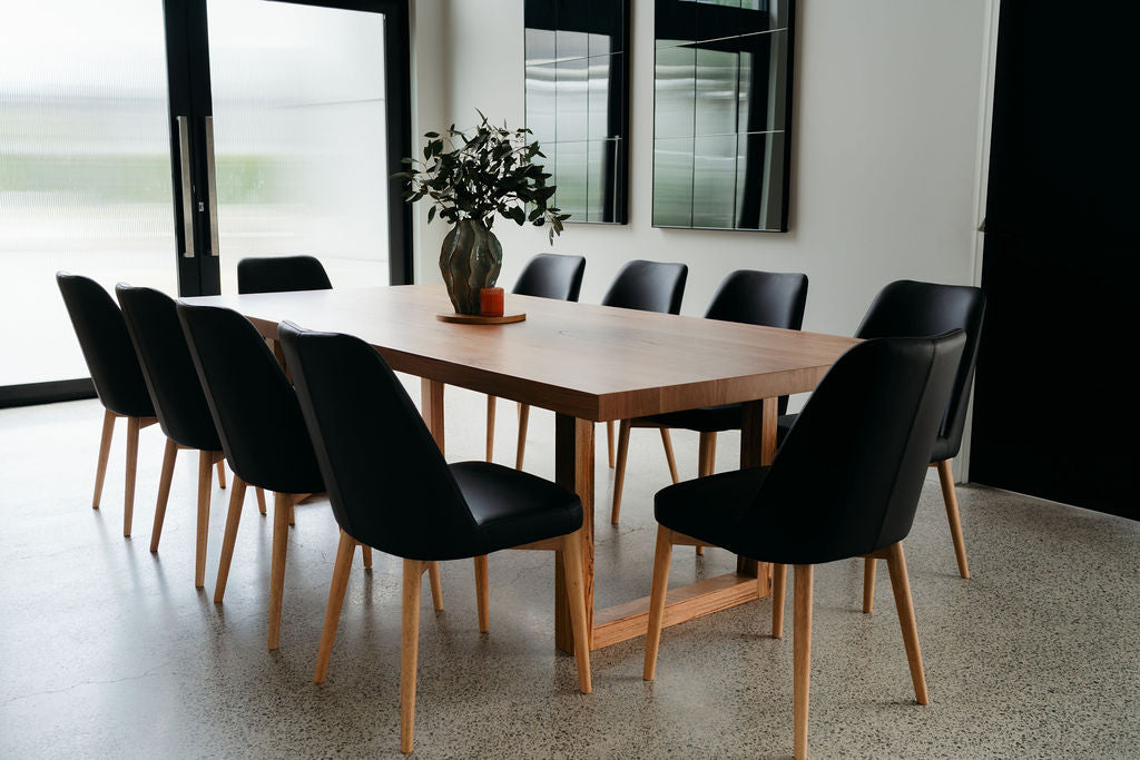 Dining table with black chairs in a modern room