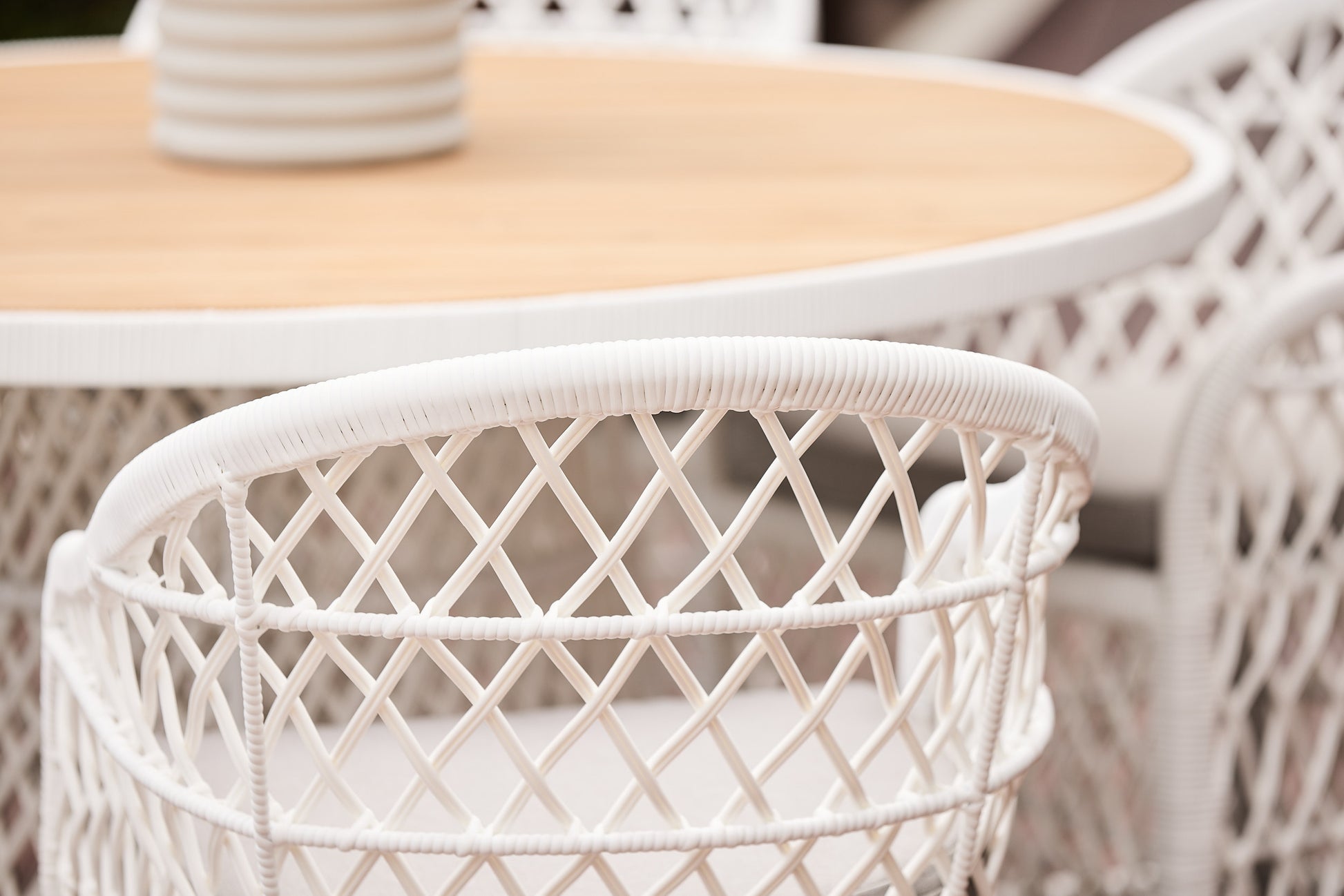 havana white synthetic wicker and round outdoor teak table setting