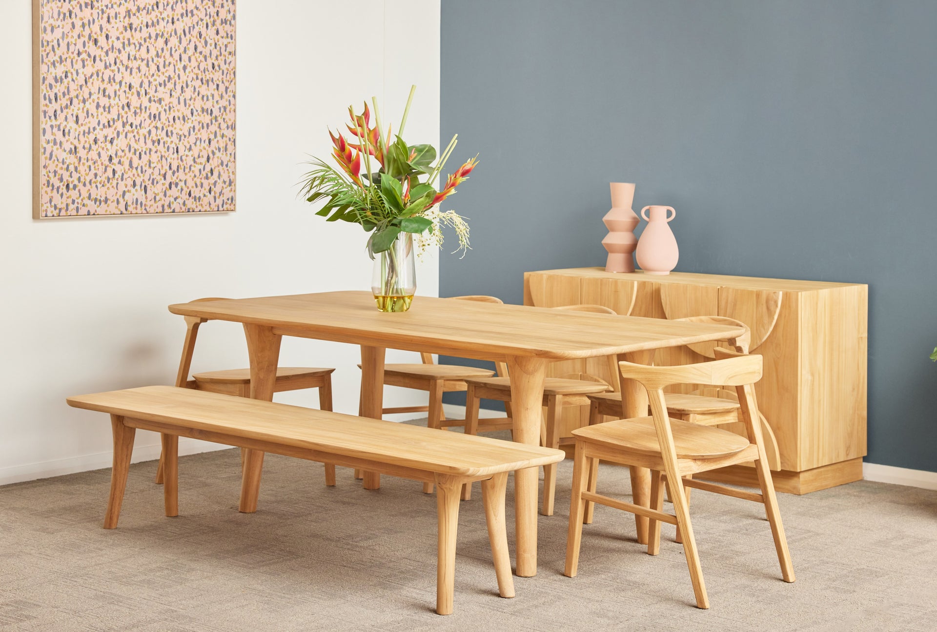 Wooden dining set with table, chairs, and bench against a gray wall.