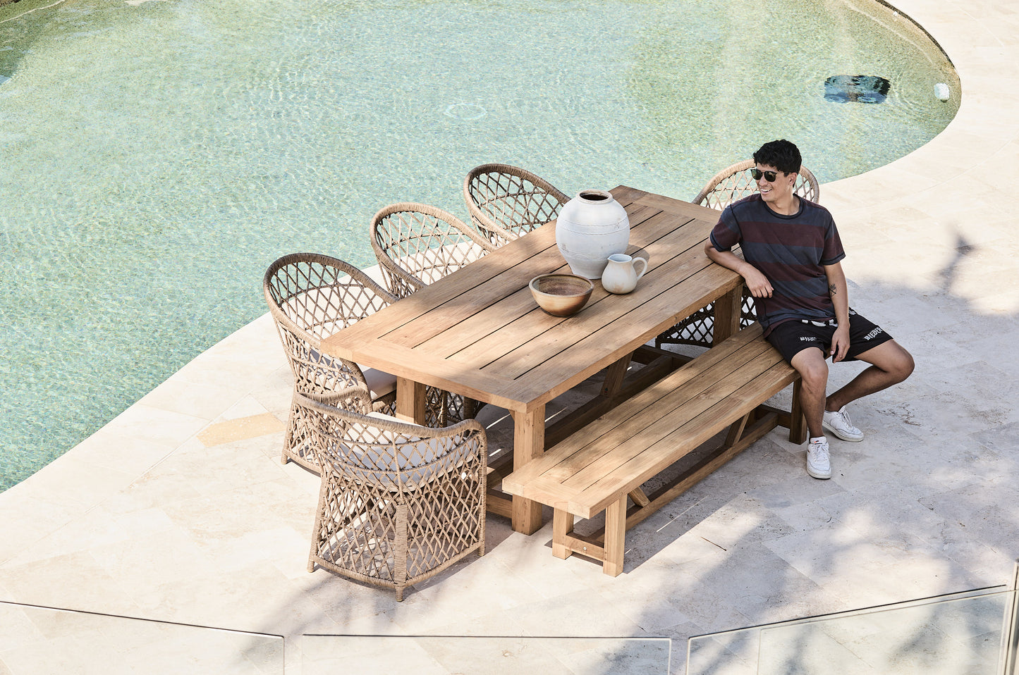 reclaimed teak bench setting with wicker bucket chairs