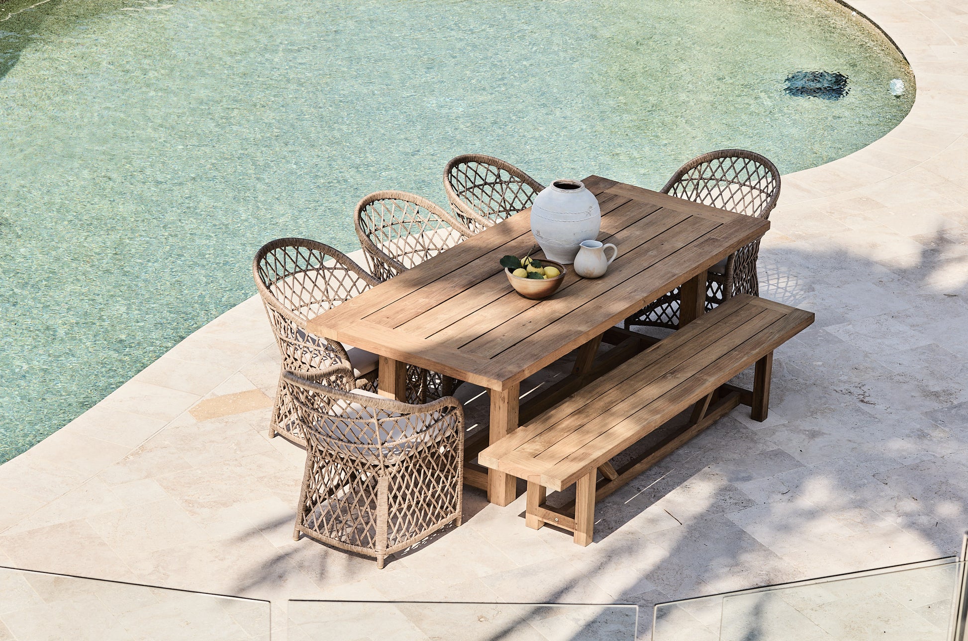 reclaimed teak bench setting with wicker bucket chairs