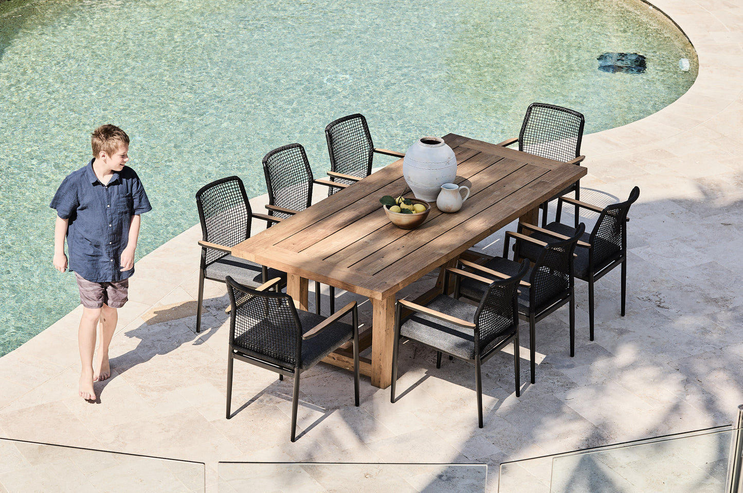 vinegard reclaimed teak outdoor table with black rope chairs