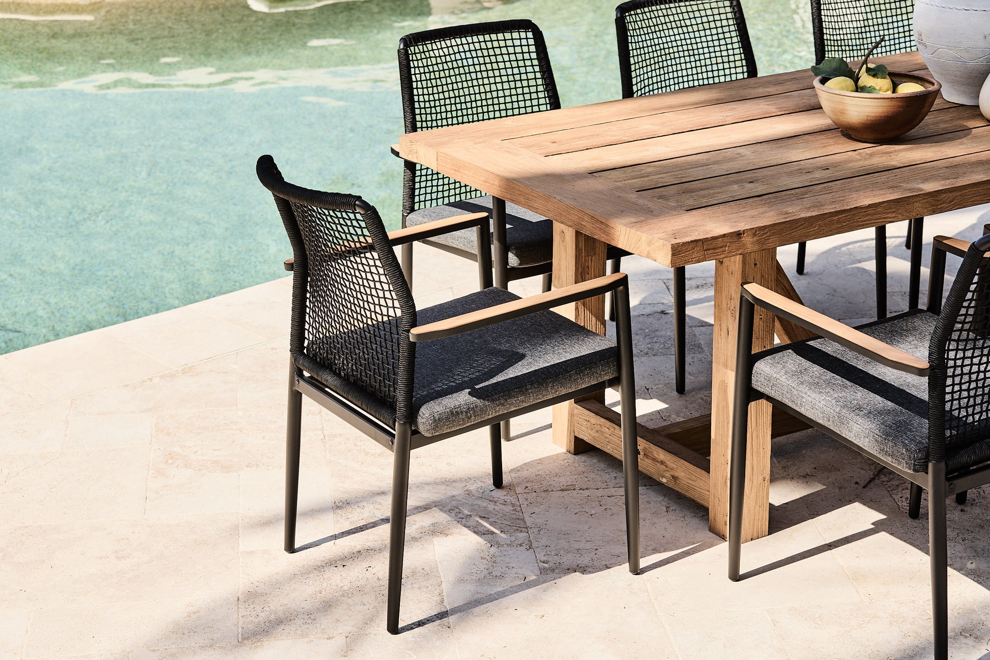 vinegard reclaimed teak outdoor table with black rope chairs