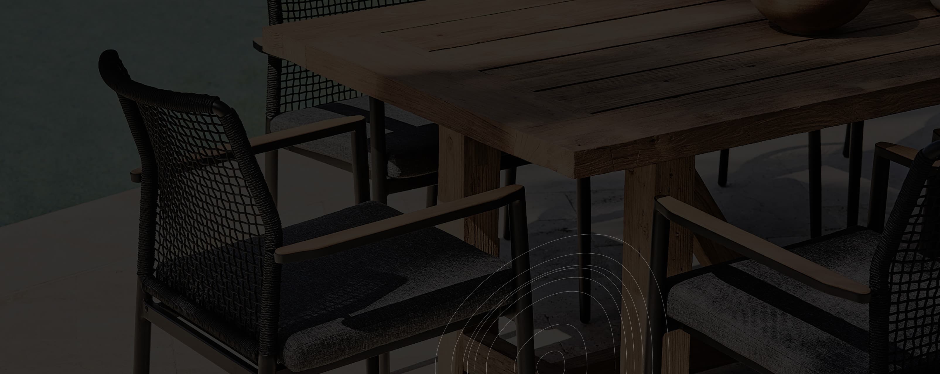 Wooden dining table with chairs in a dimly lit room